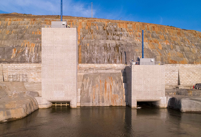 Completion of two river diversion tunnels, which are used to reroute a short section of the Peace River to allow for the construction of the main earthfill dam