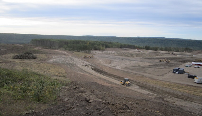 Construction equipment working on new site access roads and the site preparation for the worker accommodation camp on the north bank of the Site C dam site.