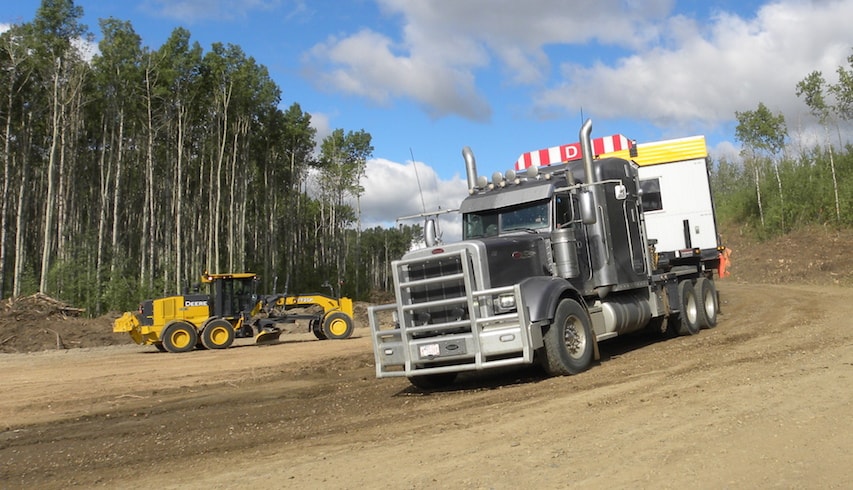 A truck delivers a modular unit to the Site C dam site for a temporary work camp.