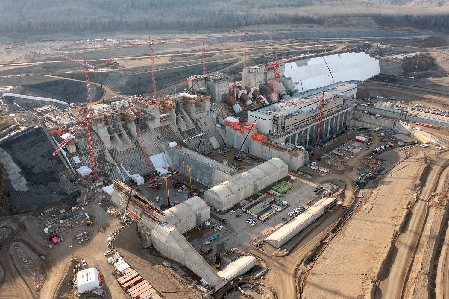 Aerial shot of the spillways basin and headworks, powerhouse and roller-compacted concrete dam and core buttress. | October 2021