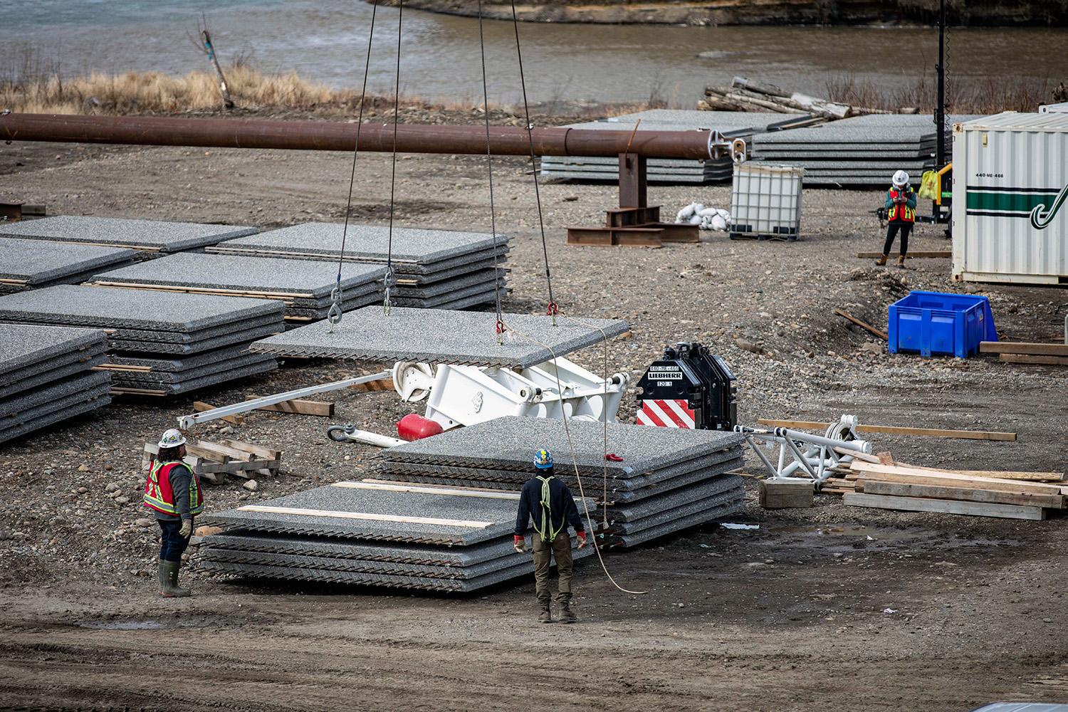 Lifting a pre-cast deck panel into place on the Highway 29 Farrell Creek bridge realignment. | May 2022