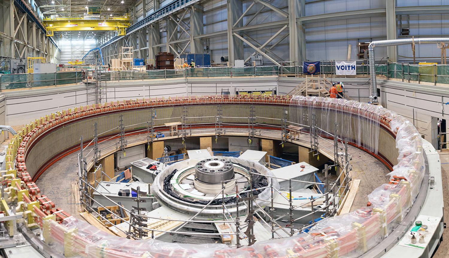 The unit 1 stator winding is completed. Thrust bearing assembly can be seen on the lower bracket. | February 2023