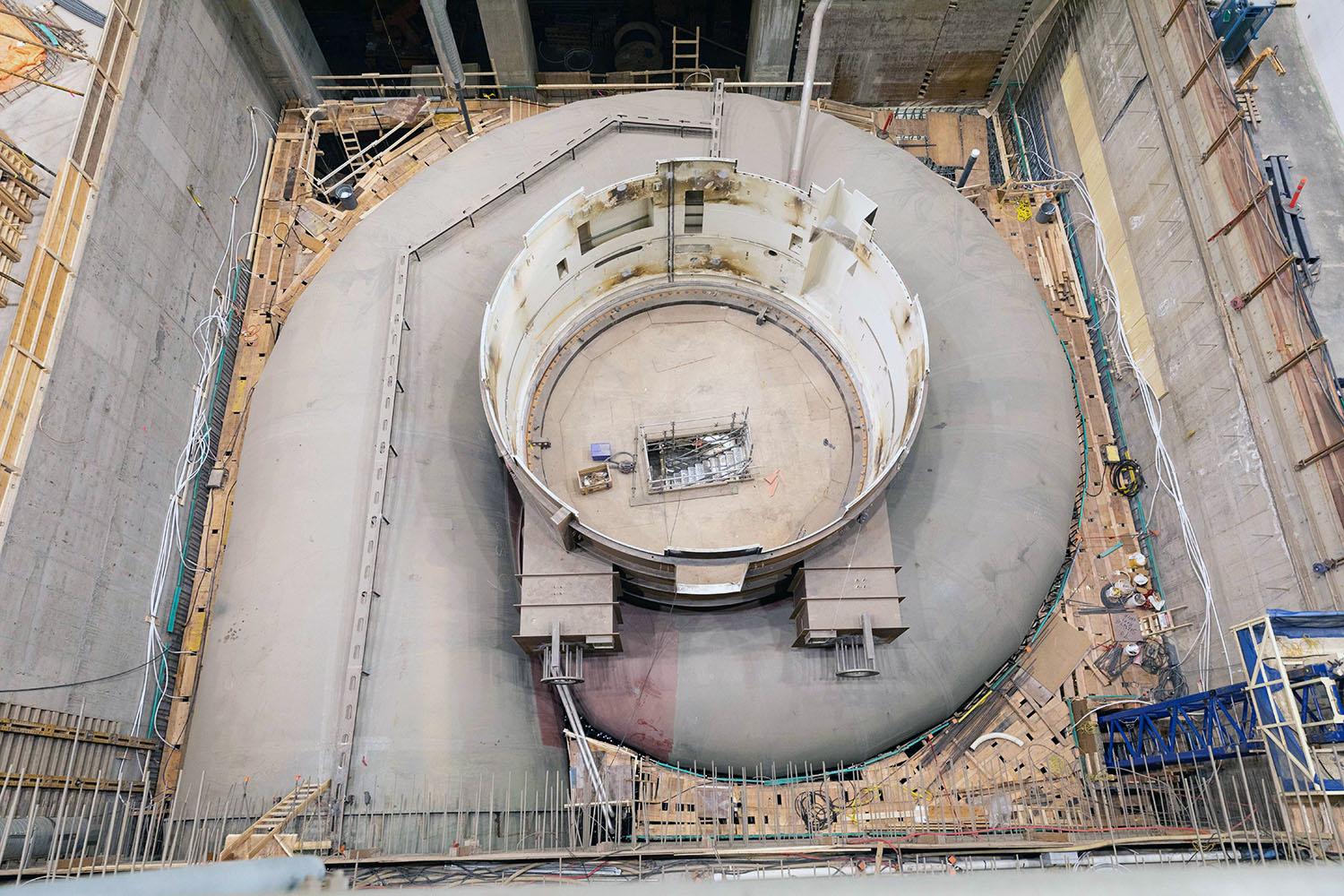Turbine unit 6 is ready to be embedded in concrete. A plywood deck has been placed on the reinforcing steel to allow the workers to place the concrete. | May 2023