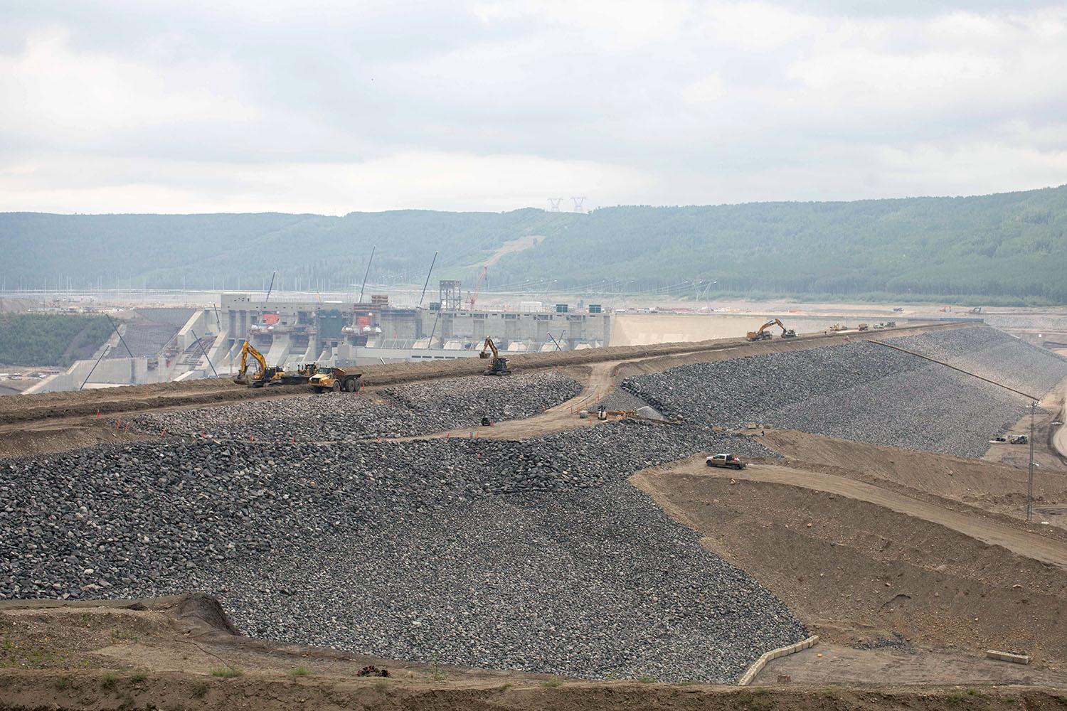 Riprap will protect the upstream shell of the dam. At centre right, the upstream debris management ramp is being built.