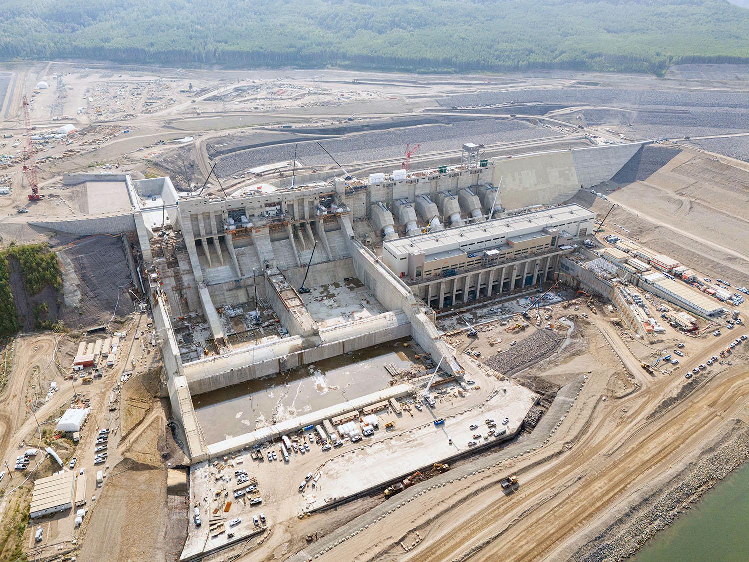 A downstream side view shows Site C’s spillways, penstocks, and tailrace.