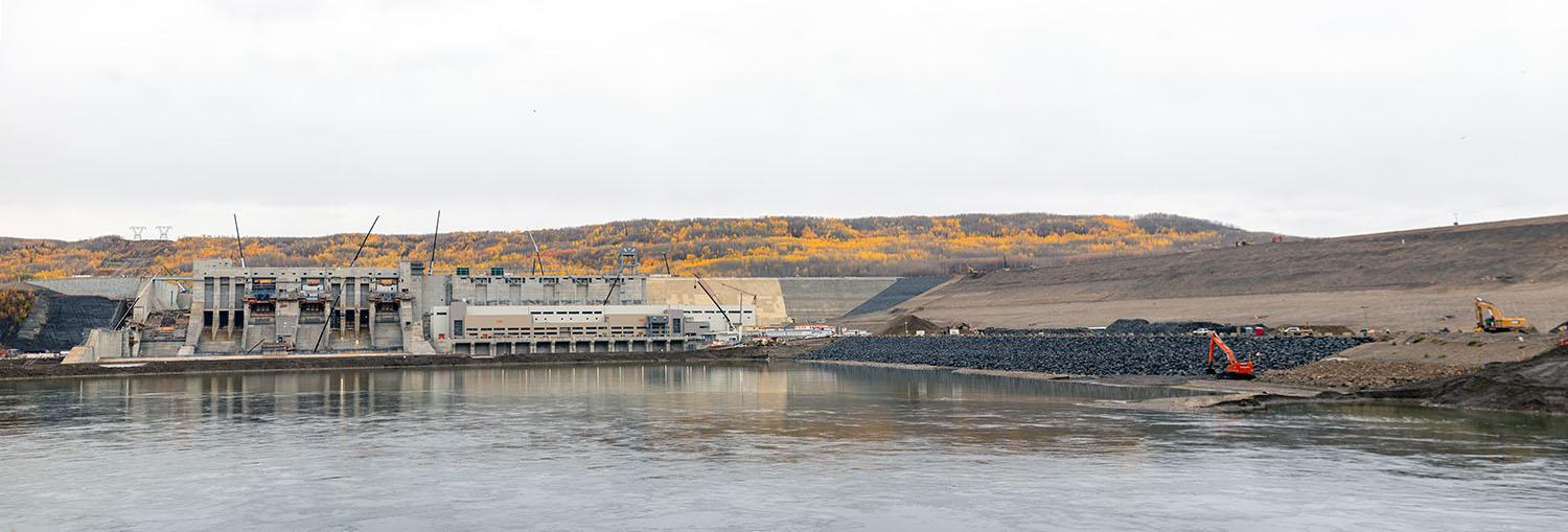 A boat access ramp is being constructed on the downstream side of the earth fill dam.