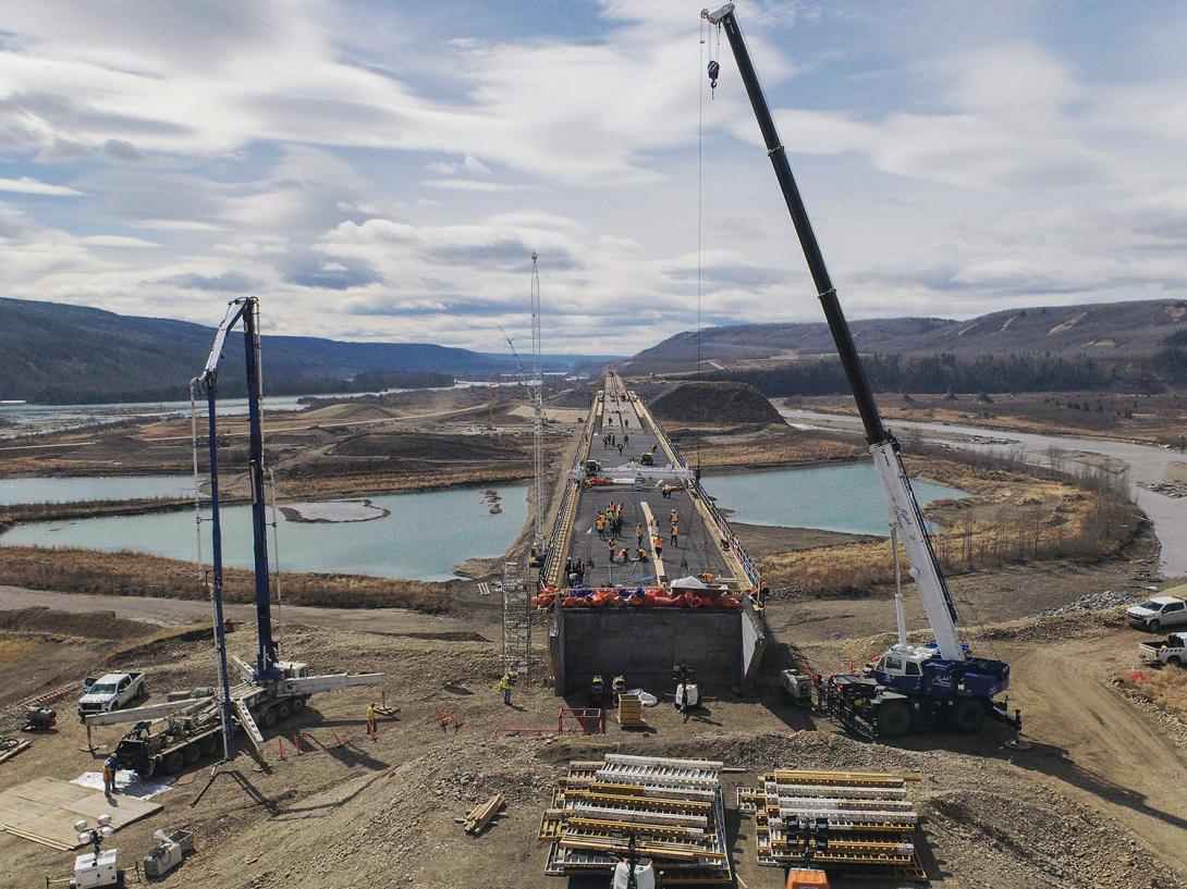 Preparing the Halfway River bridge deck for the first concrete placement on April 29. Concrete is placed using a concrete pump truck and then levelled with a screed machine, which moves on rails to level the concrete to the correct thickness and slope for the deck. | April 2021  