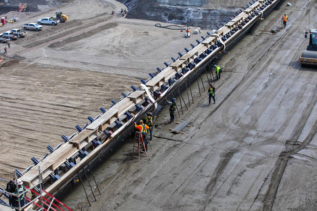 Installation of reinforcing steel on the south face of the roller-compacted concrete dam and core surface. | May 2021