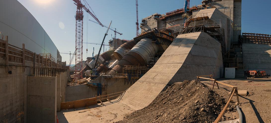East-facing view of five of six penstock units in varying stages of construction. | July 2021