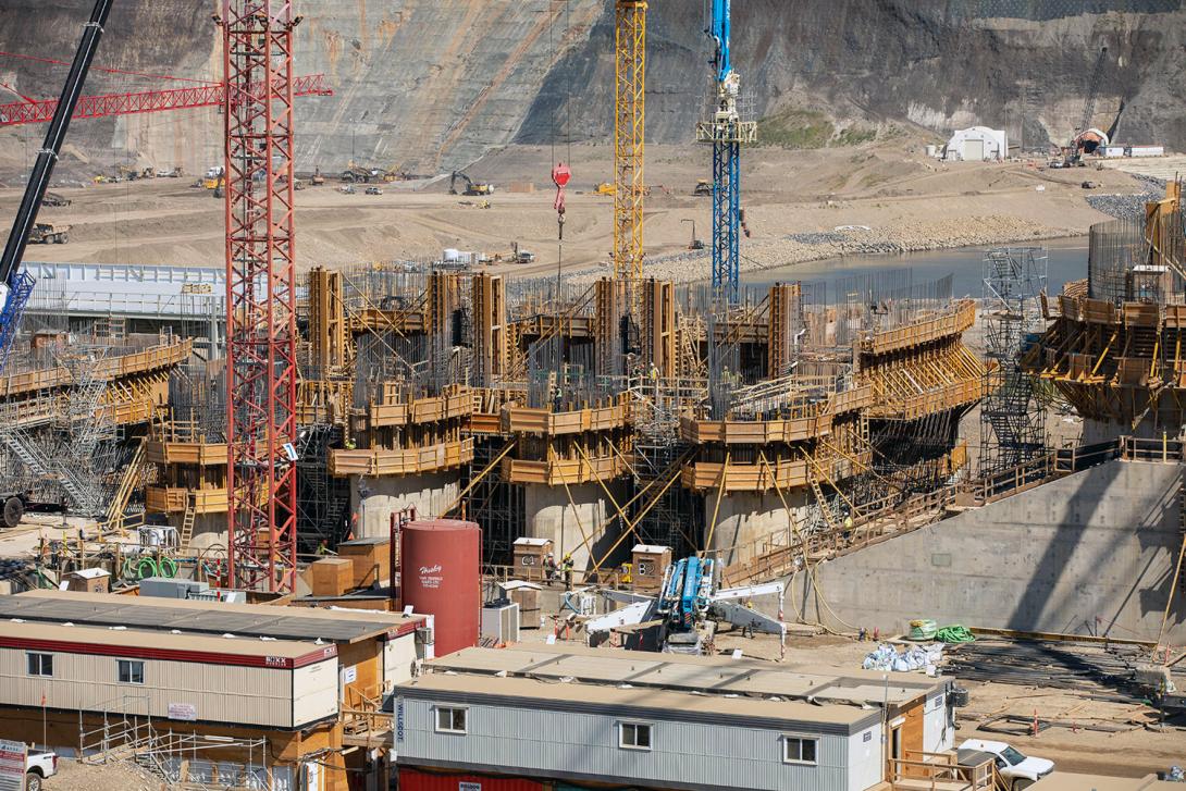 The west low-level outlet piers at the spillway are under construction. | July 2021