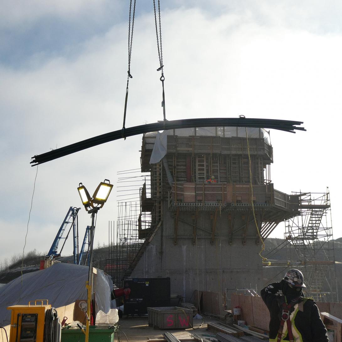 A lift of rebar is lowered at intake unit 6.