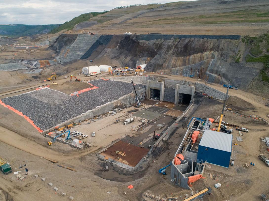 The completed diversion tunnels outlet portals on the north bank and temporary fishway (pictured lower right) nearing completion. | May 2020