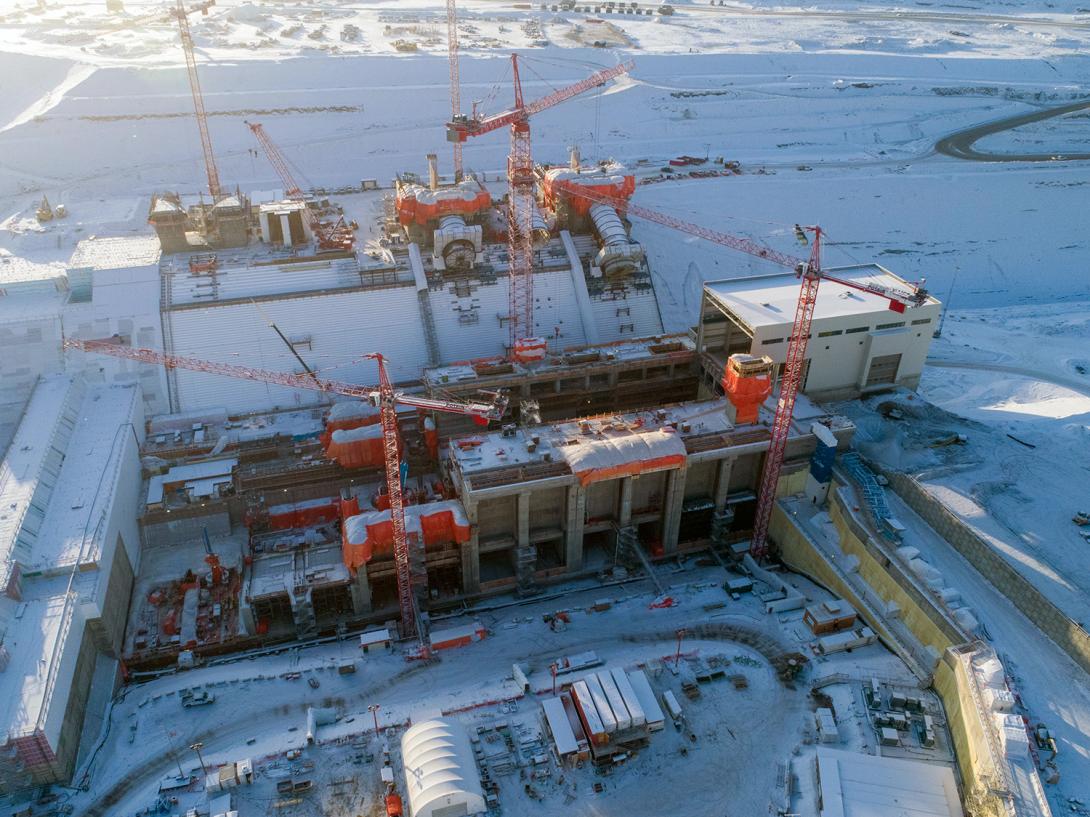 A snowy, winter view of the powerhouse, main service bay and penstock units 1, 2 and 3. | December 2019