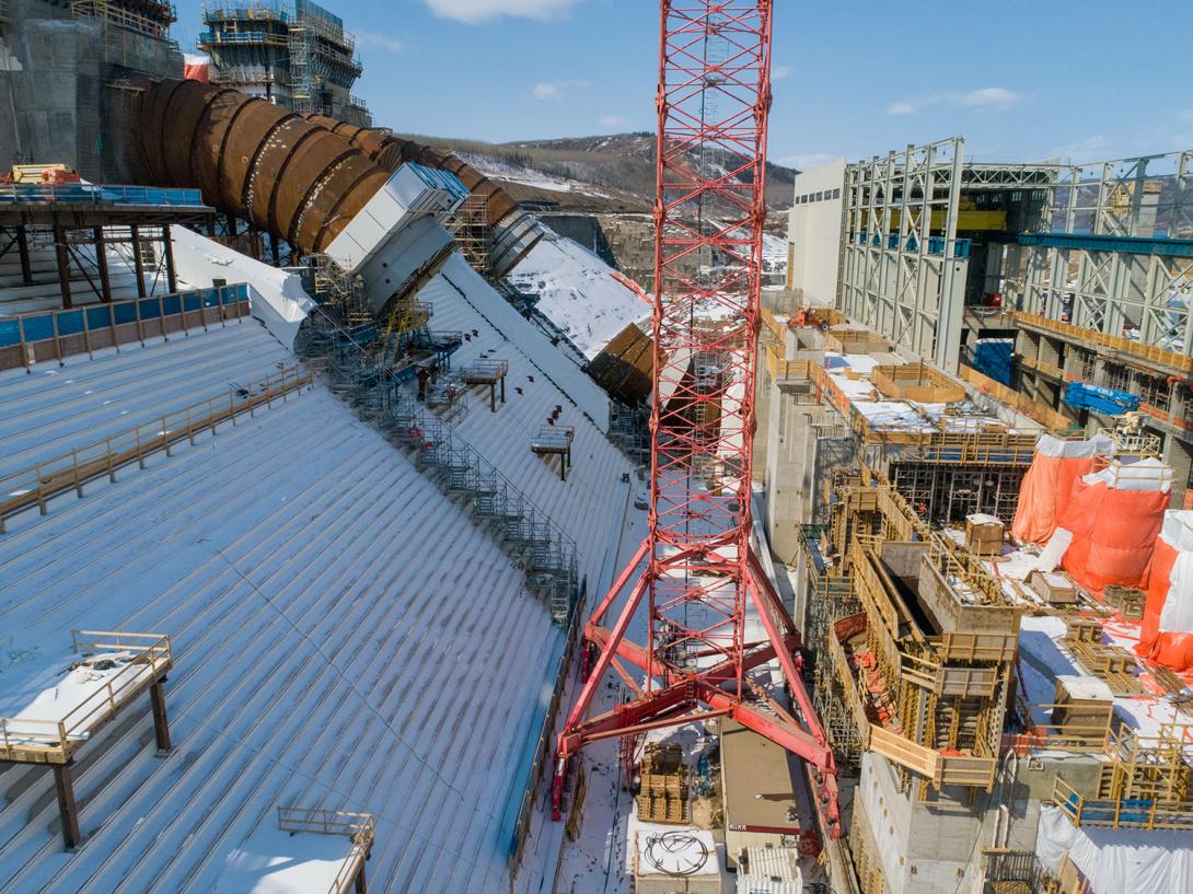 Tower crane 3 is in the foreground. It is used to lift penstock rings into place to be welded together. Penstock unit 3 and unit 1 can be seen behind the crane. | April 2020