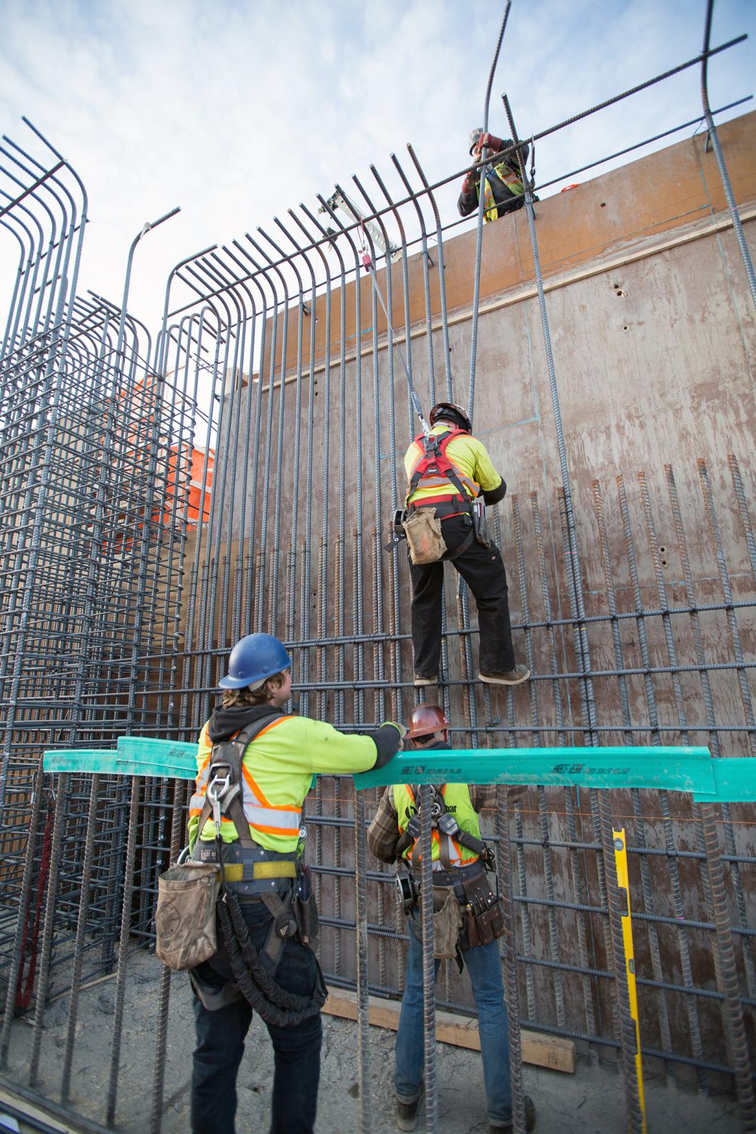 Workers installing rebar in the main service bay. | December 2018