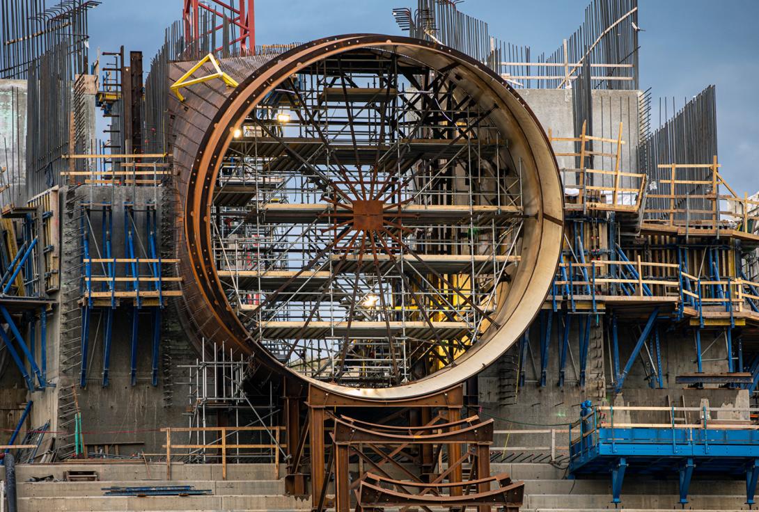 Looking upstream at the intake structure and penstock for unit 6 under construction. | July 2020