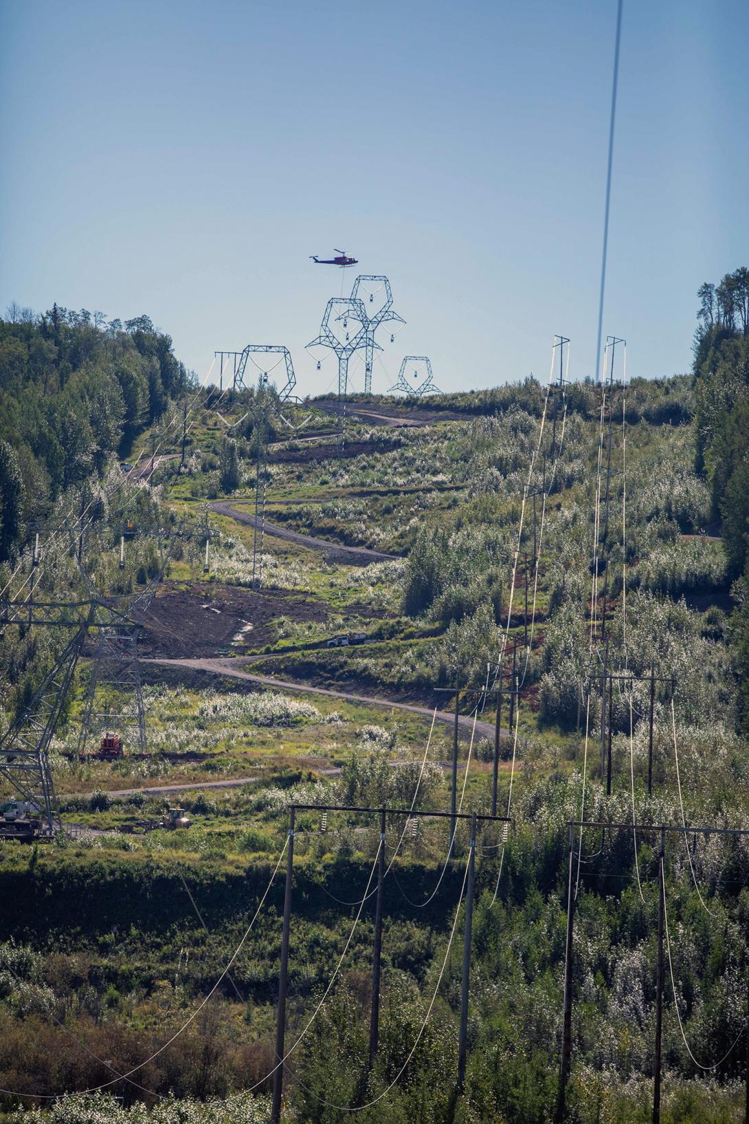 A helicopter installs the sock line on the 500 kilovolt transmission towers near Peace Canyon Dam. | August 2020