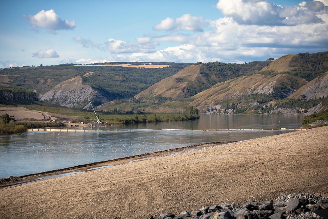 Debris booms are in position upstream of the inlet portal to help manage debris woody debris the Peace River. | August 2020
