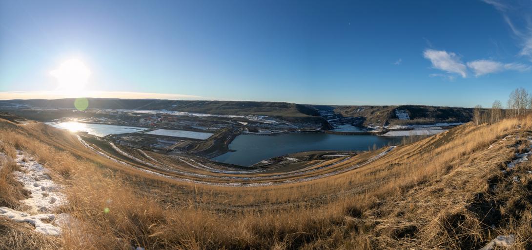 An view from the Site C north bank overlooking the the downstream cofferdam (left), the upstream rockfill berm (centre-right), and head pond (right). | December 2020