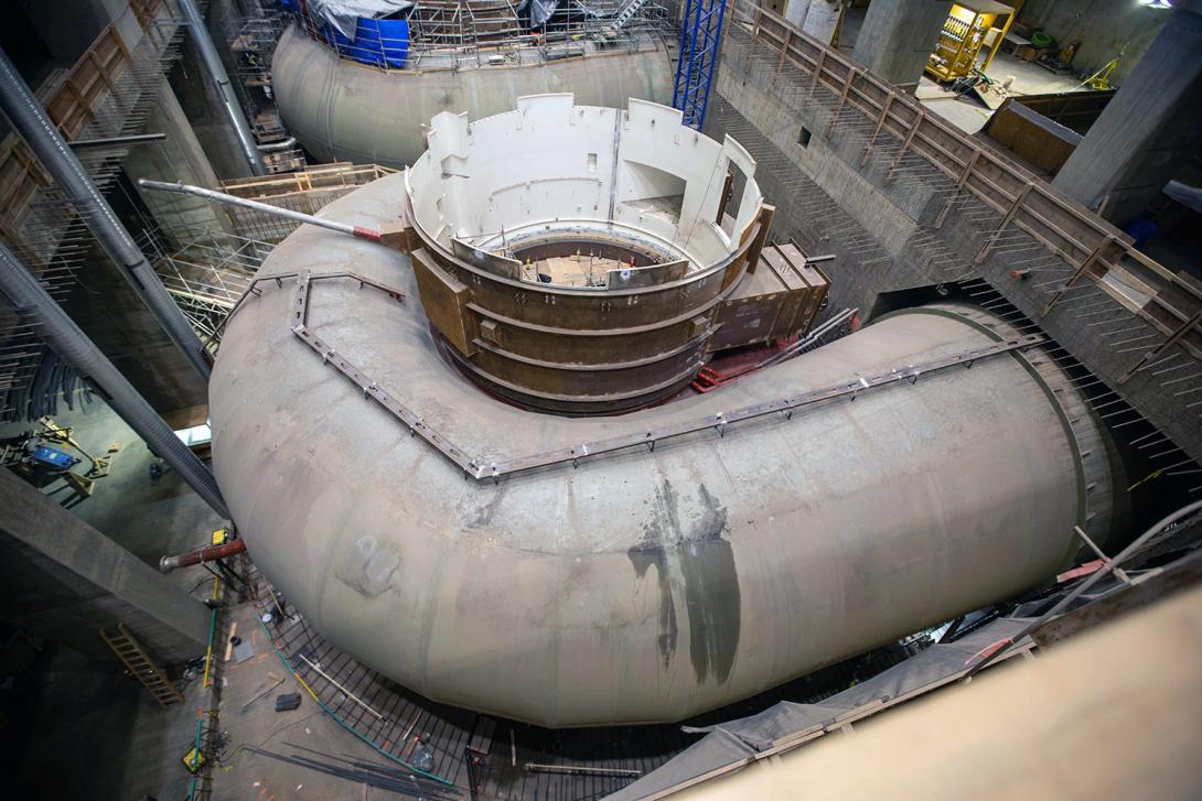 Crews install the unit 1 pit liner and spiral case inside the powerhouse.