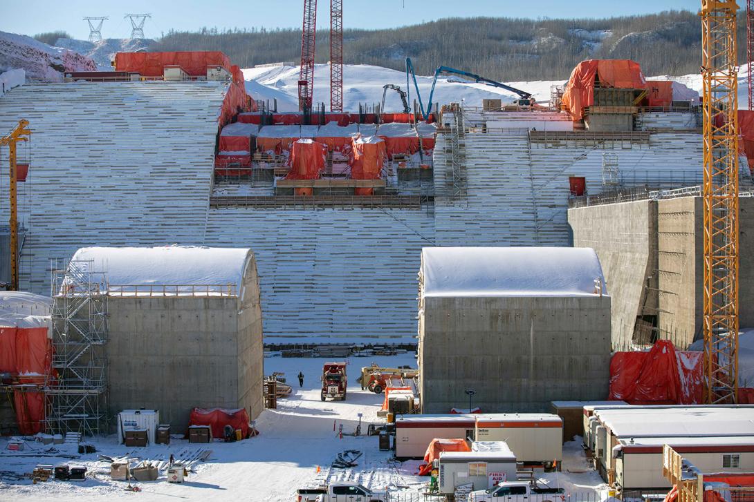 Crews pour concrete at the lower level spillway gates. The dam spillways will allow the passage of large volumes of water from the reservoir into the river channel downstream. | February 2021