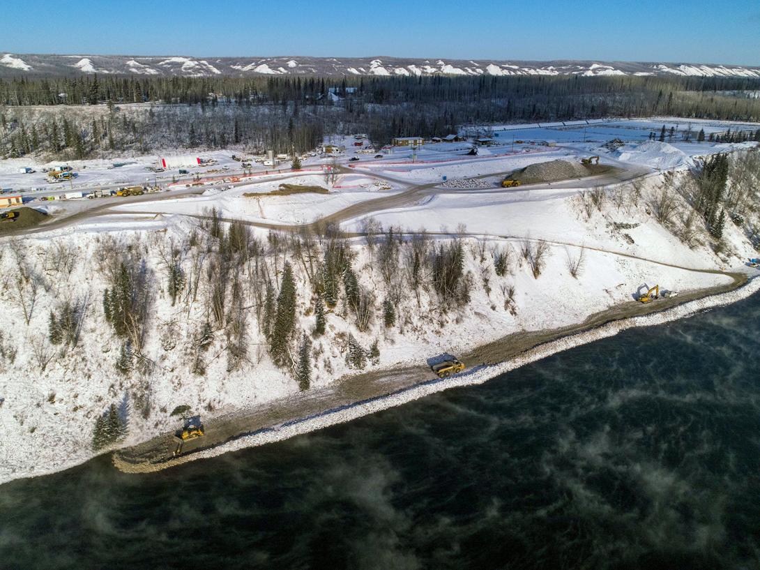 Construction of the shoreline protection at Hudson’s Hope advances. Activities occurring on site include vegetation clearing and stripping of material from the shoreline, hauling of riprap from Portage Mountain Quarry to site stockpiles, and hauling riprap from the site stockpiles and placing in the river to build the berm. | January 2021