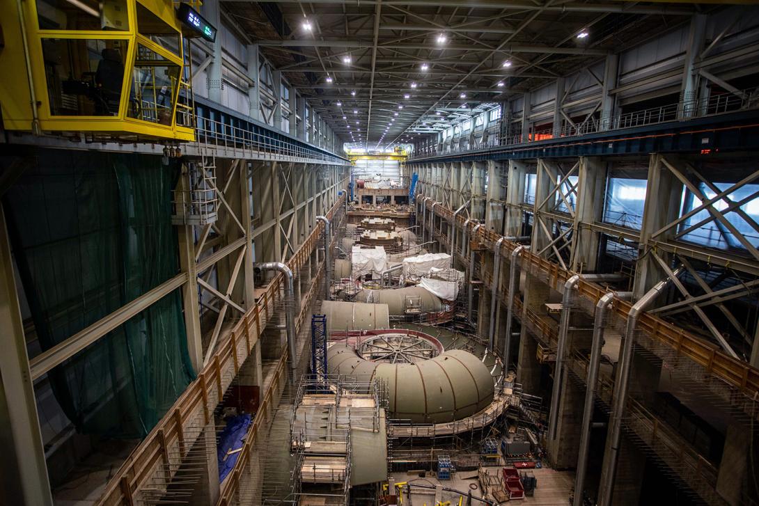Turbine units in varying stages of construction in the powerhouse. | March 2022