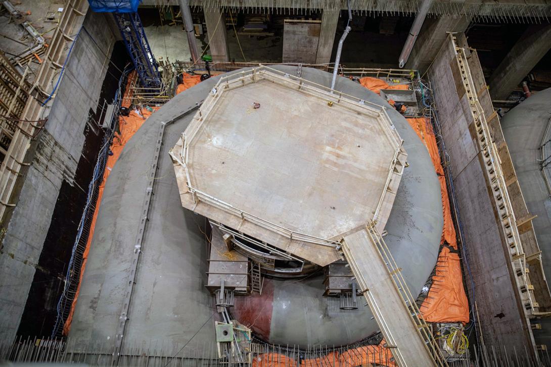 The first lift of concrete is curing on a spiral case. The working platform is sitting on top of the upper pit liner. | April 2022