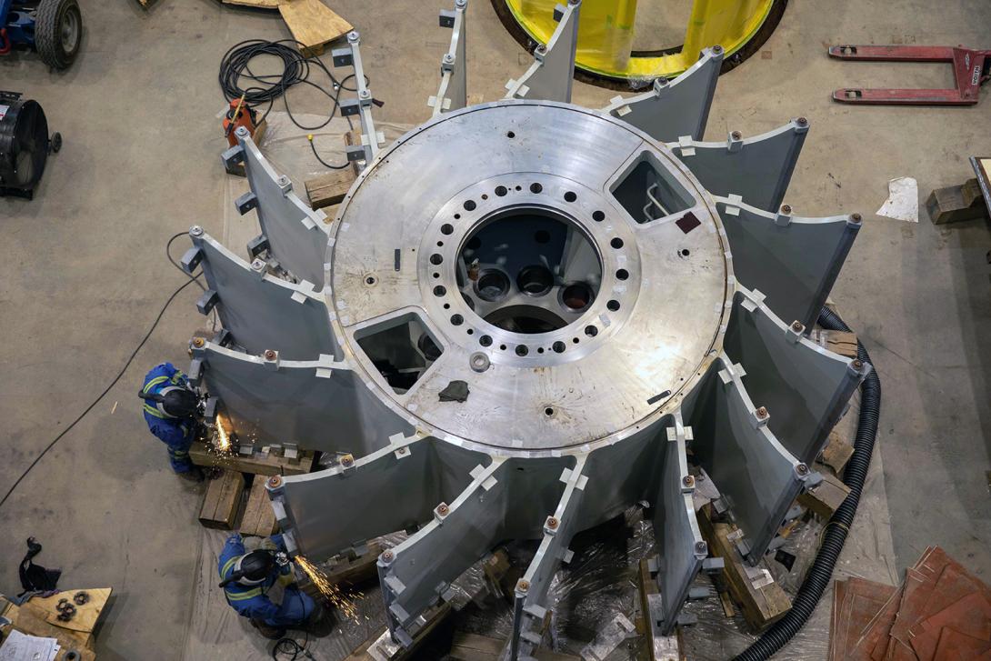 Welders prepare joints for welding on a rotor hub in the main service bay of the powerhouse. | April 2022