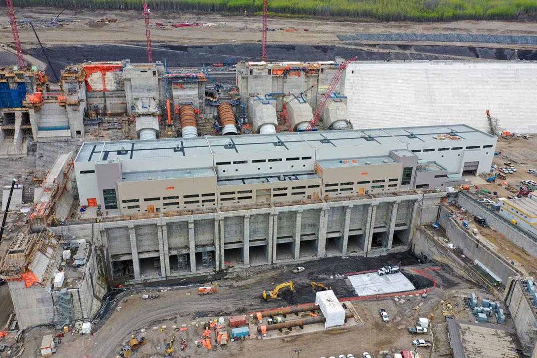 The powerhouse and operation building are substantially complete, with foundation enhancement work ongoing in front of the tailrace. | May 2022