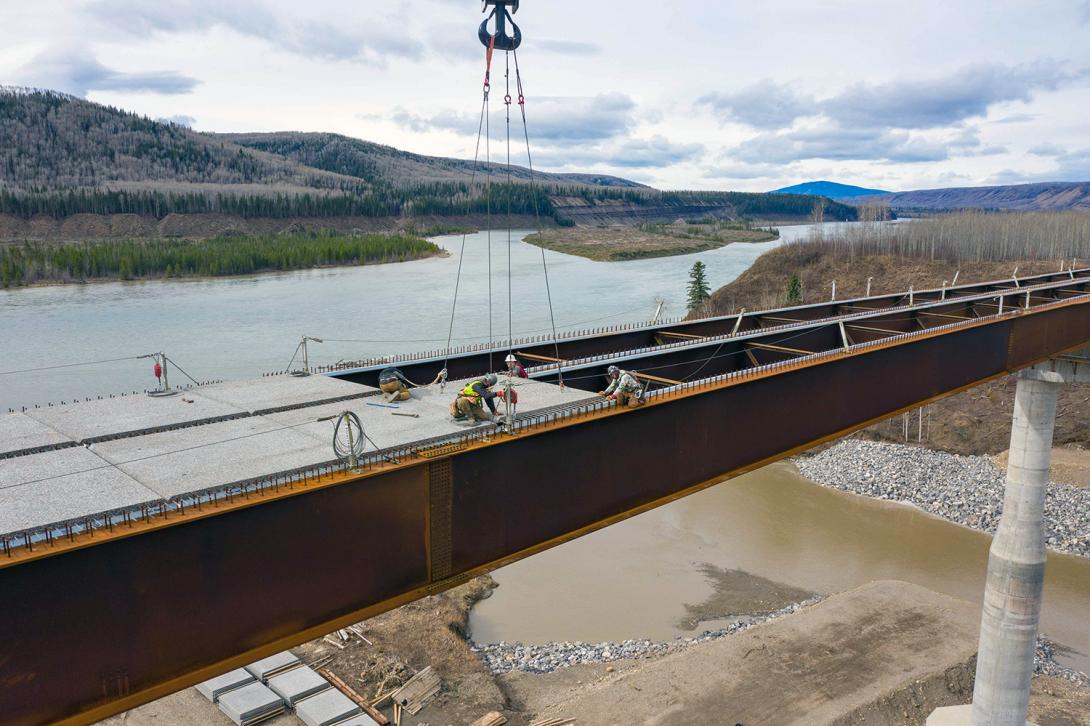 Pre-cast concrete panels are moved into position on the Farrell Creek bridge at the Highway 29 realignment. | May 2022