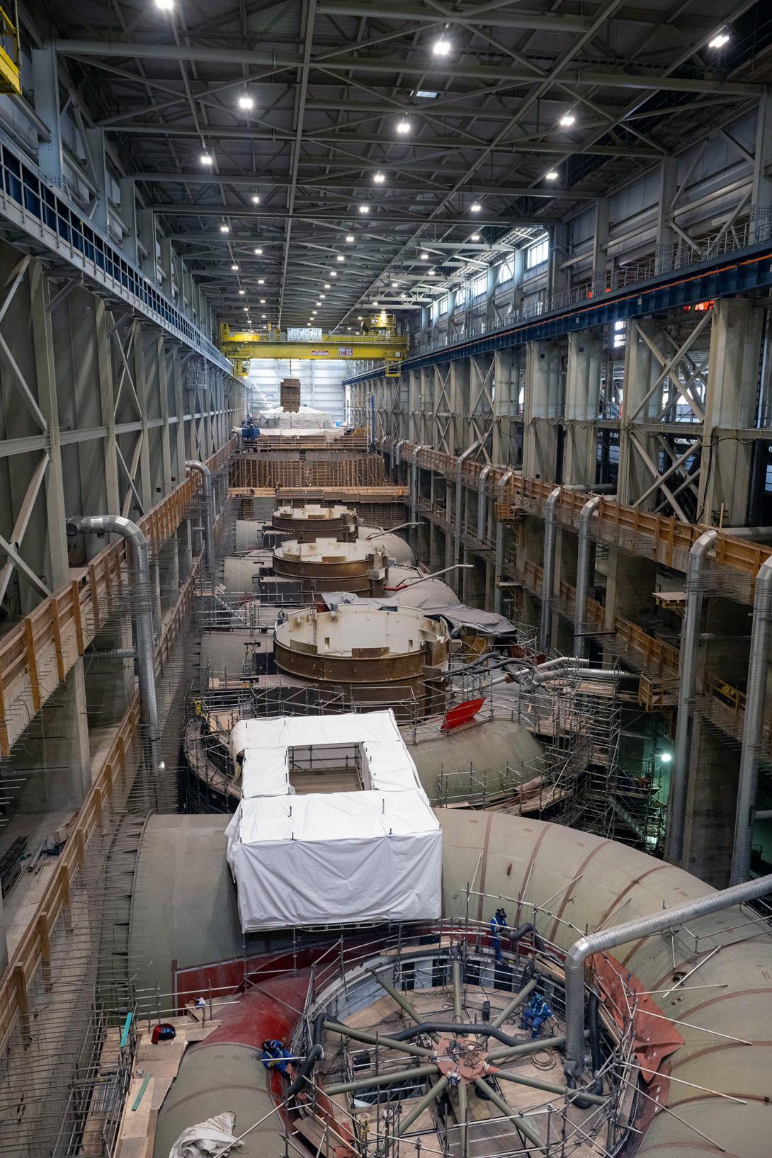 Units 6 to 1 inside the powerhouse are in varying stages of construction. | June 2022