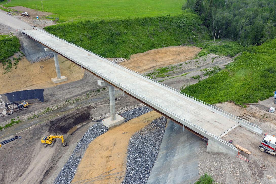 Dry Creek Bridge final slope treatment below the bridge and work on the east approach continues. | June 2022