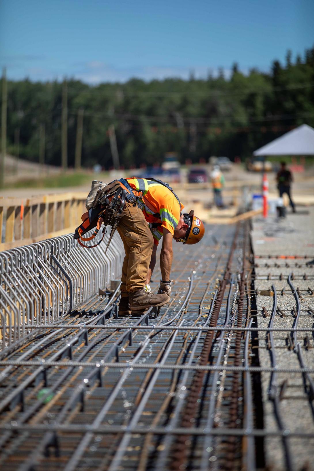 A construction worker installs rebar on the Farrell Creek bridge deck. | July 2022