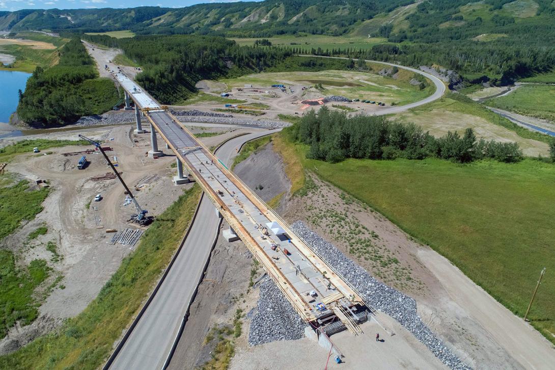Aerial view of Farrell Creek bridge construction, showing bridge deck concrete and rebar progress. | July 2022