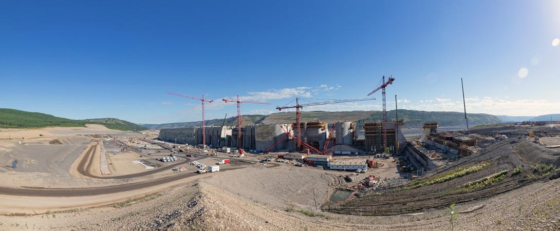 Panorama of the approach channel with a view of the roller compacted concrete buttress, the intake gates and spillway upper headworks. | July 2022