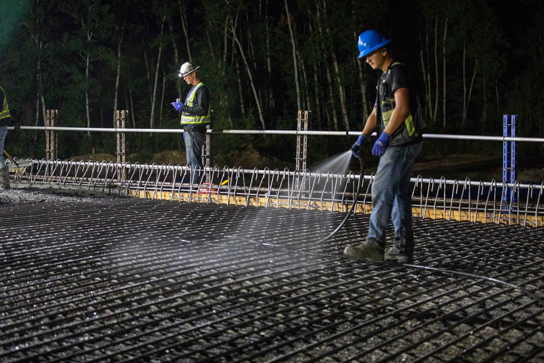 Cleaning precast panels and rebar before concrete is poured for the Farrell Creek Bridge deck. | August 2022