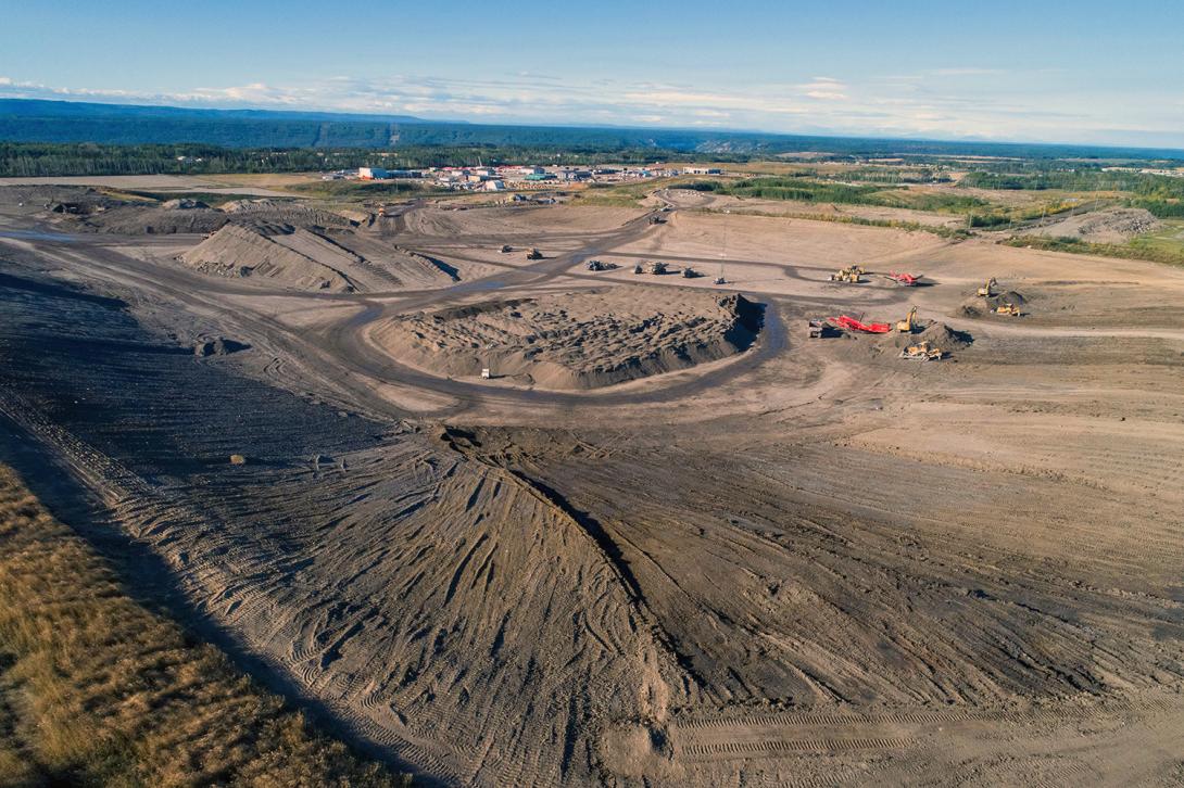 An aerial view looking across the 85th Ave industrial lands where glacial till is sourced and used to build the dam. | September 2022