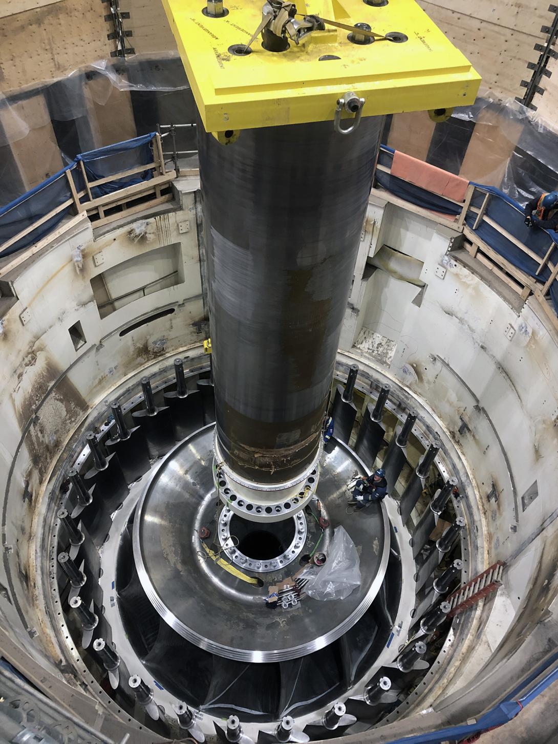 Lowering unit 1 turbine shaft into position in the turbine runner. The shaft connects the turbine to the generator to produce continuous power. | November 2022