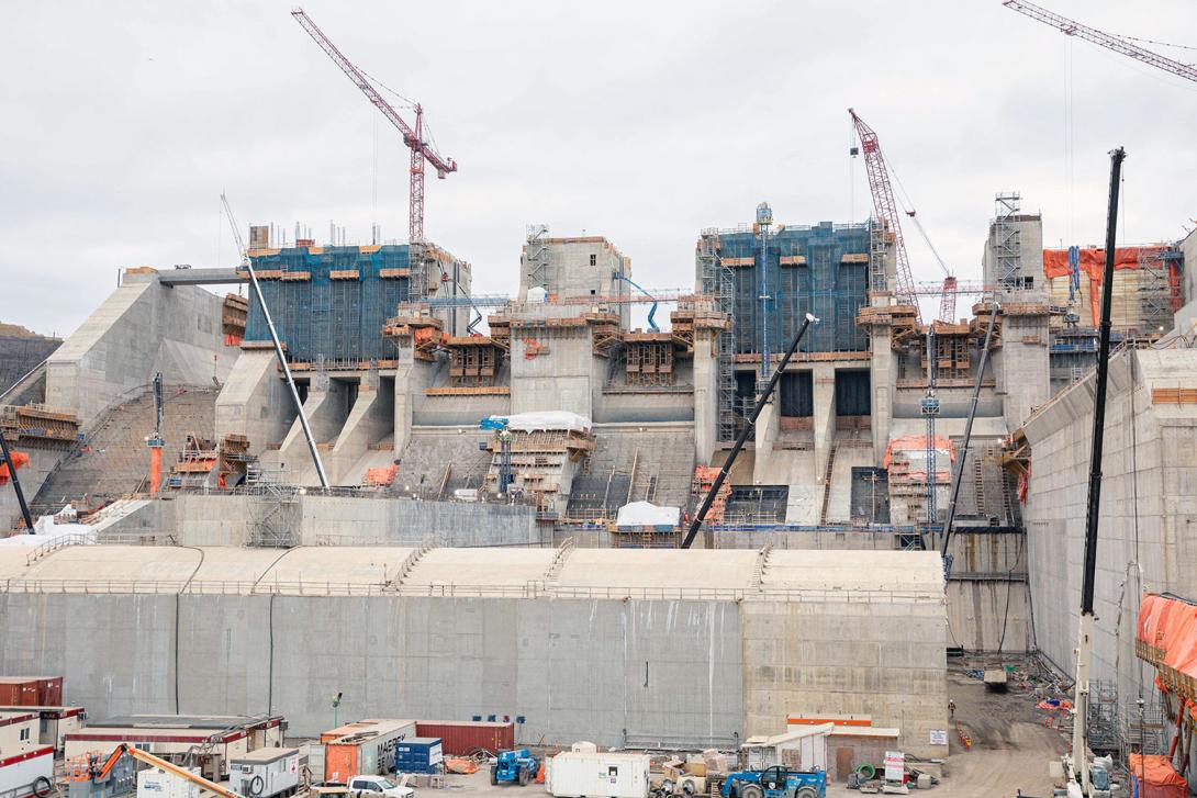 From left: the auxiliary spillway, the three spillway operating gates, six low-level operating gates, and the stilling basin weir in front. | November 2022