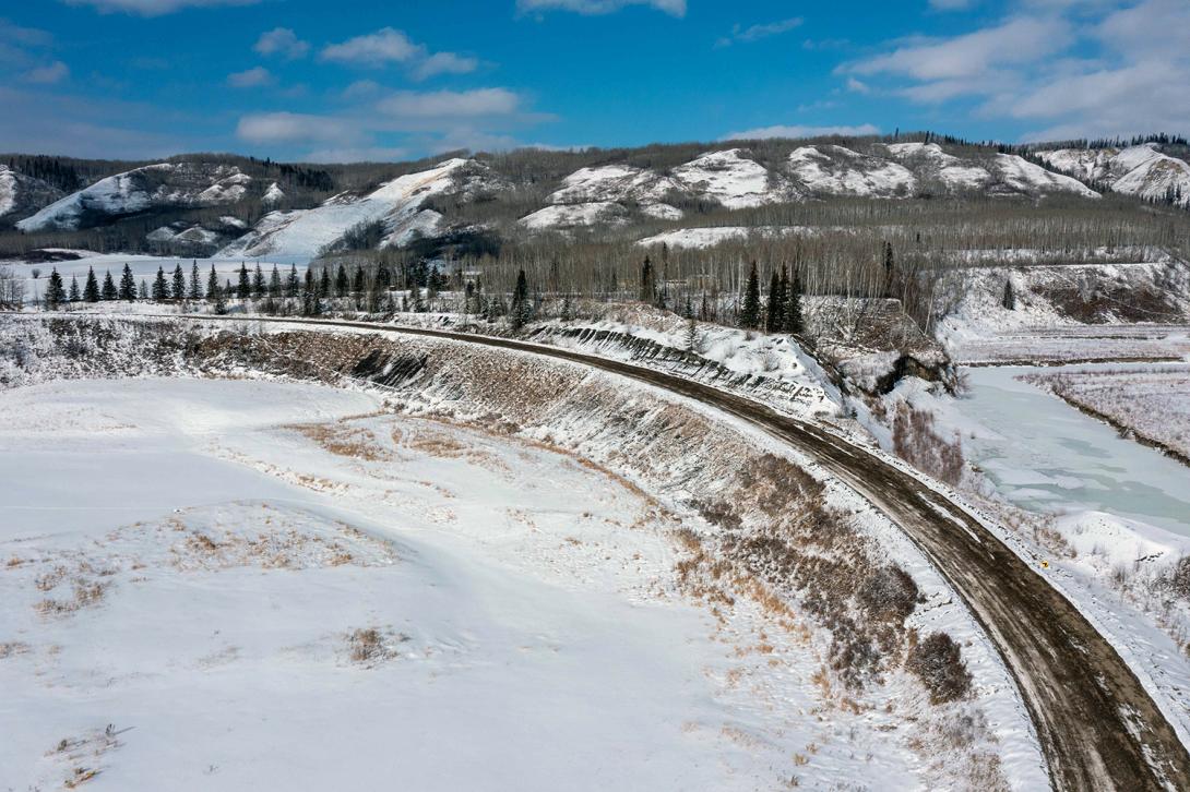 The asphalt and sub-base gravel from the original section of Farrell Creek on Highway 29 has been broken and hauled away to be ground and re-used in future road construction. | March 2023