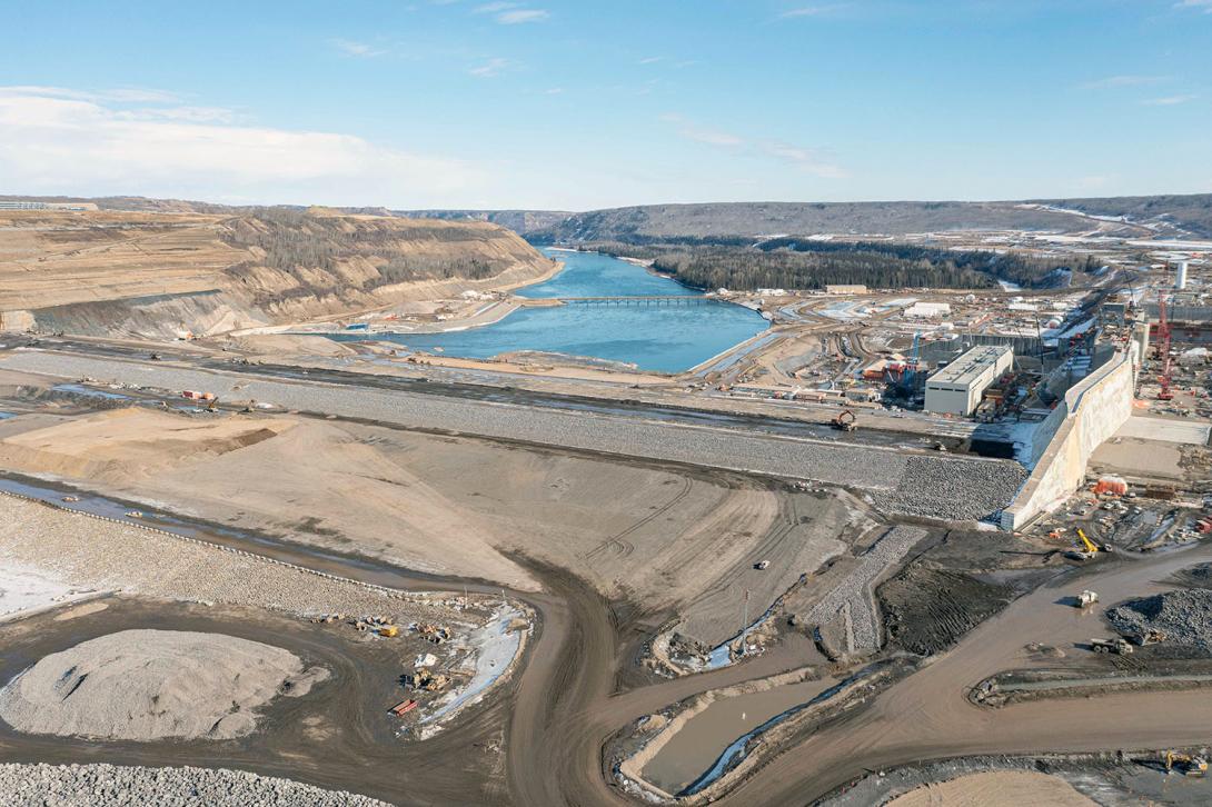Water from the Peace River will flow down the approach channel on the far right and exit the Site C dam downstream. | March 2023