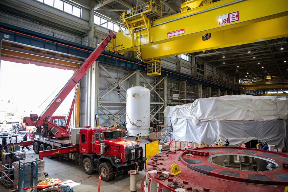 Two cranes lift and install an air receiver tank. The tank stores pressurized air to run different types of equipment. | April 2023