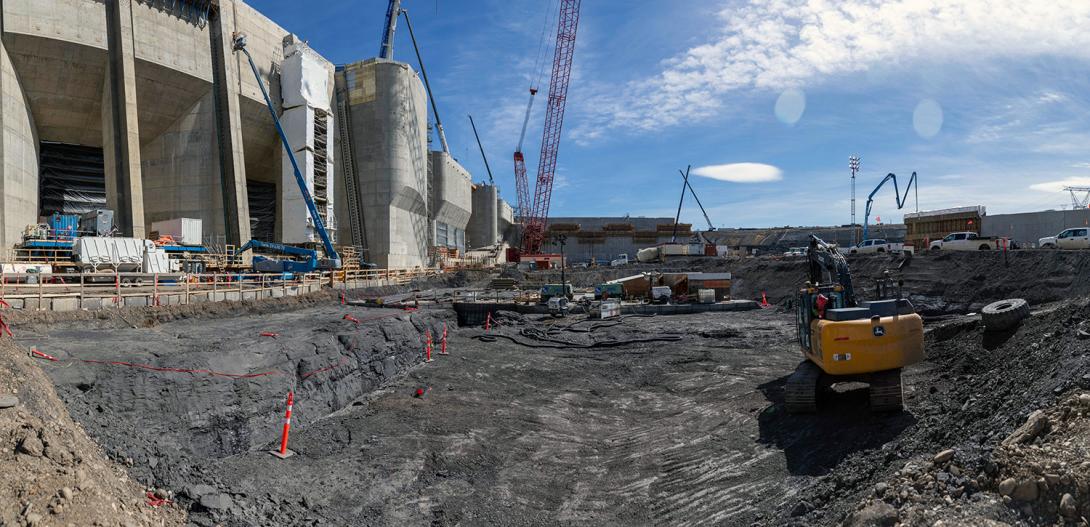 Crews clean the bedrock layer before placing concrete in the approach channel. | April 2023 