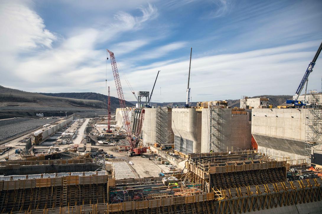 Concrete is placed on the passive spillway, which operates without power and safely passes water that would otherwise go through the mechanical spillways. | April 2023