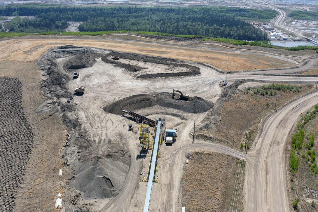 The conveyor belt moves glacial till to a stockpile area on the construction site, where trucks then haul it to the dam core. | May 2023