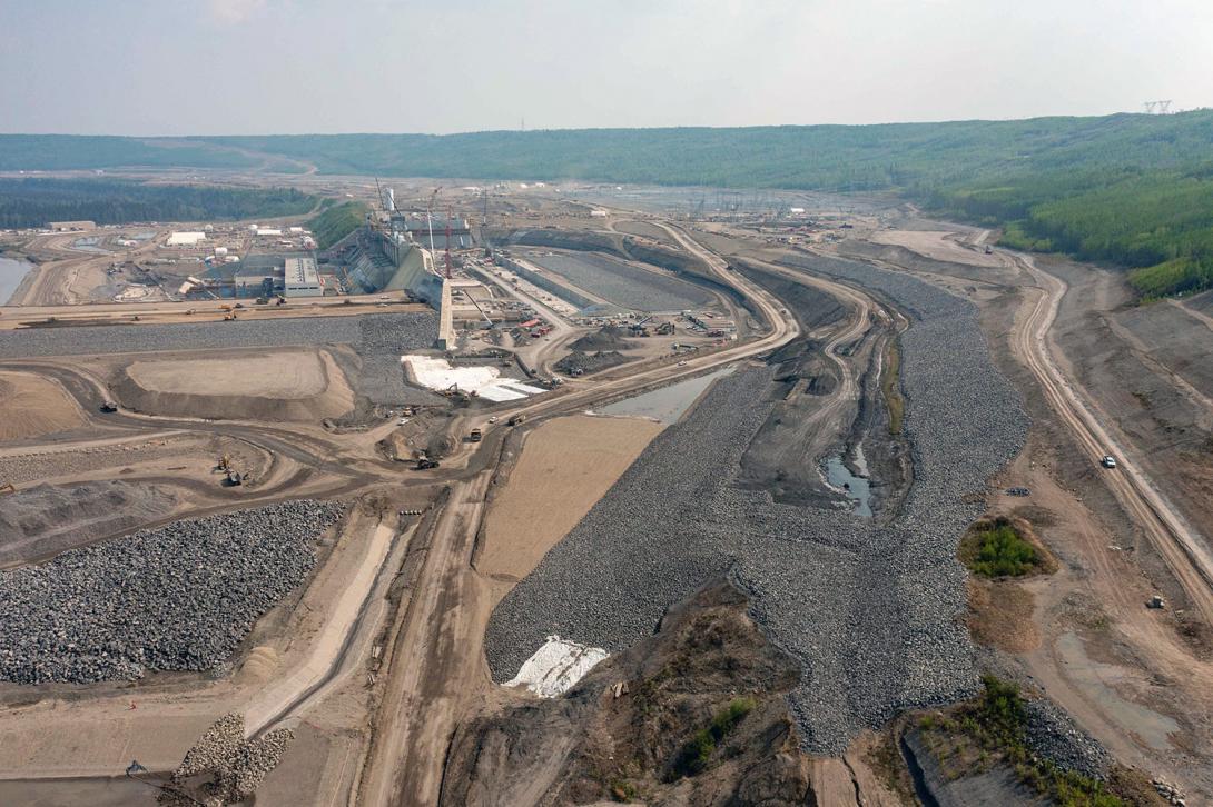 Downstream view of the approach channel. Water from the reservoir flows into the channel where it enters the intakes and drops down the penstocks into the turbine units and generates electricity. | May 2023