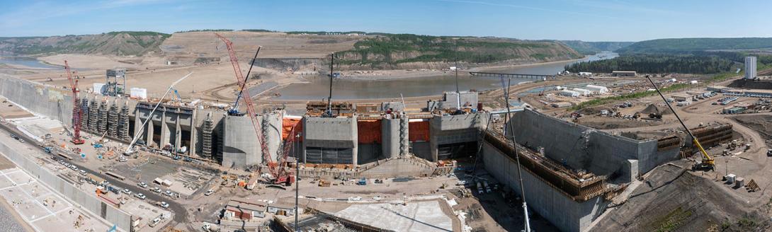 From left centre the dam buttress, intakes, mechanical spillways, the auxiliary spillway, and the spillway end-wall. | May 2023