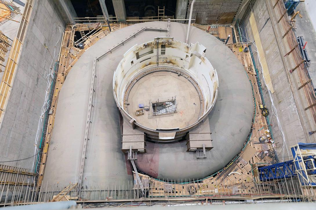 Turbine unit 6 is ready to be embedded in concrete.  A plywood deck has been placed on the reinforcing steel to allow the workers to place the concrete. | May 2023