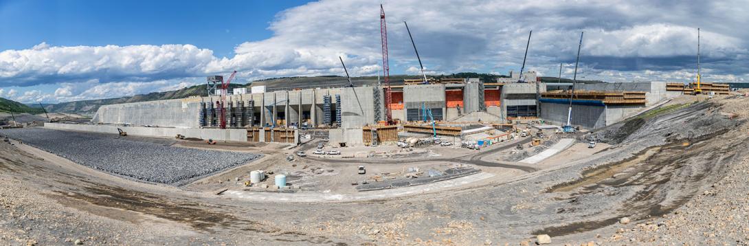 Northwest-facing view of the approach channel where water will flow from the reservoir into each of the six intake units to deliver water to the turbine units to generate electricity. | May 2023